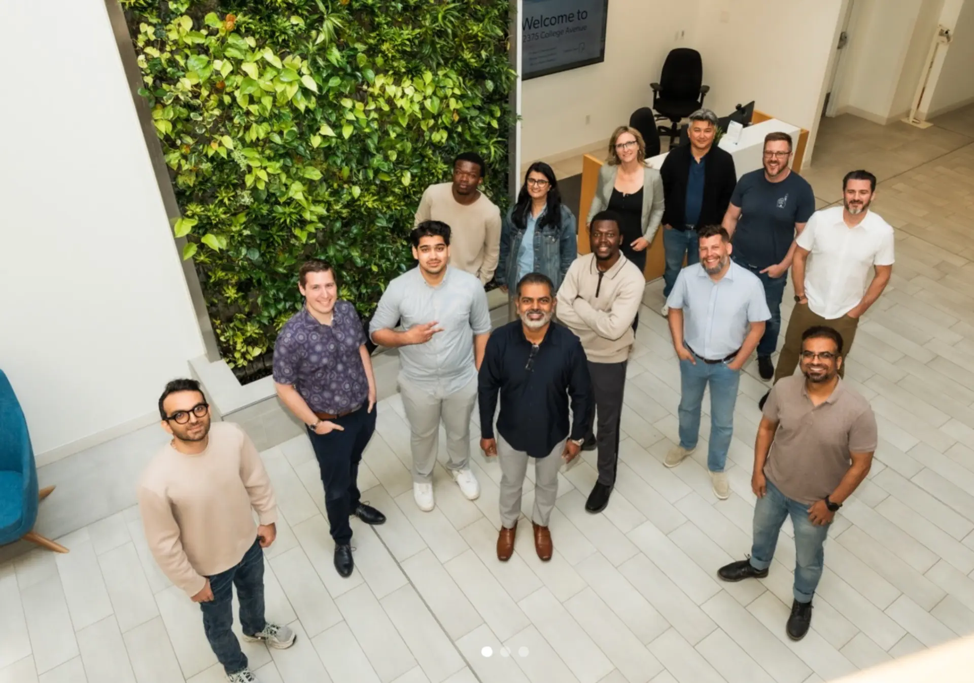 The aeax founding team working together in an office atrium