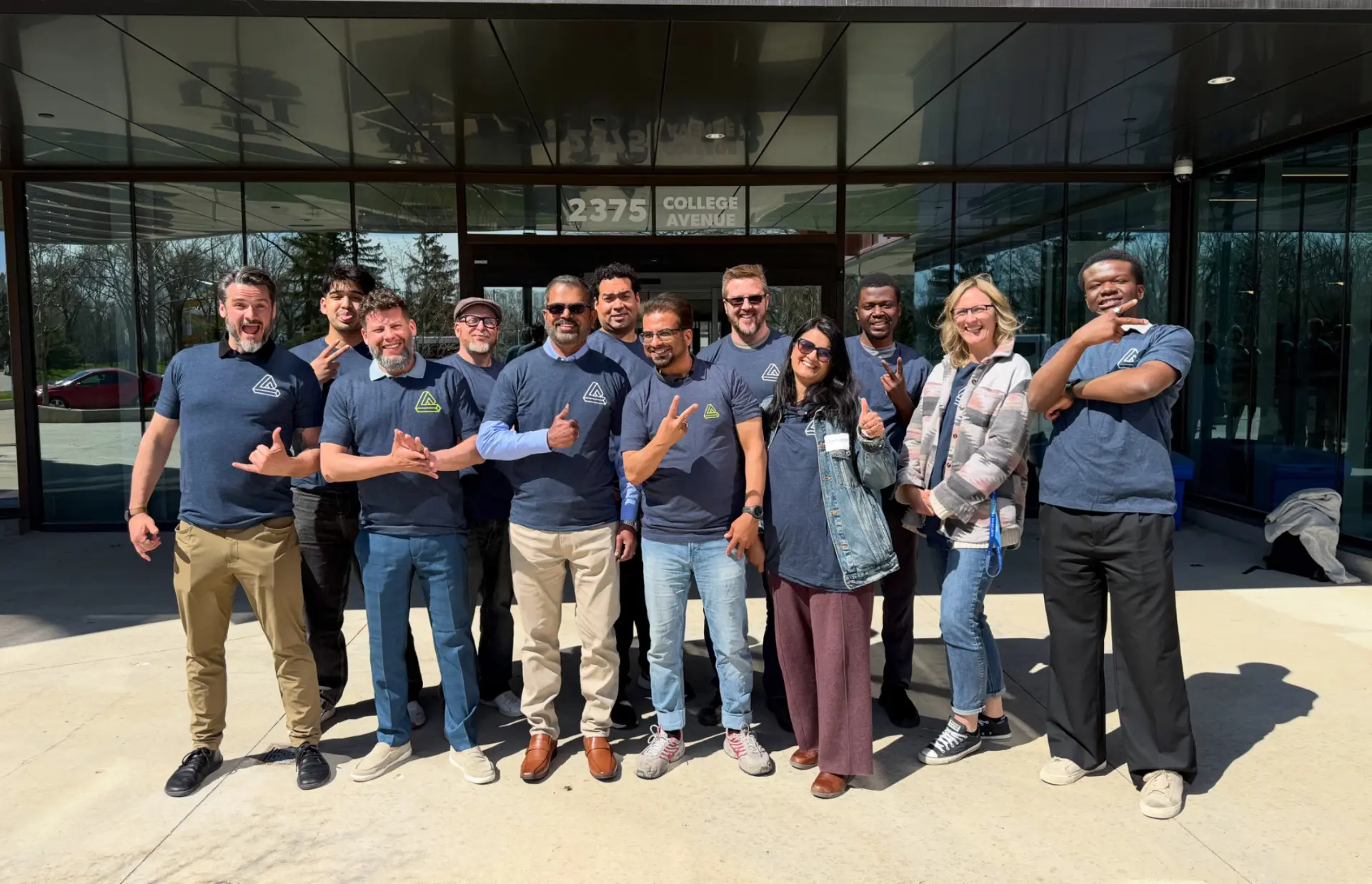 The aeax founding team at the entrance of their office building